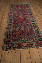 Vintage Lilihan runner close-up of cherry red field with delicate vinery, floral motifs. Shows mostly even wear.