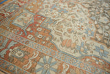 Main border of vintage distressed Malayer carpet with faded blue and terracotta pomegranate motifs.