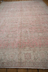 Distressed vintage Sparta carpet, mostly even wear visible across faded pink vinery.