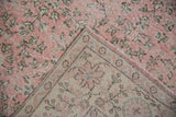 Distressed pink vintage Sparta rug pile, revealing foundation wear and hand-knotted beige reverse.