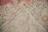 Folded distressed Turkish Sparta rug, showing blush and beige pile, fringe, and reverse.