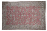 Vintage Distressed Sparta carpet, dusty raspberry field, scrolling floral palmettes, foundation showing.