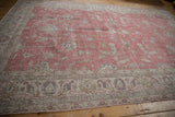 Distressed vintage Turkish Sparta carpet, showcasing worn ivory borders and a faded raspberry field.