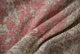 Distressed vintage Sparta rug with worn pile in raspberry, ivory, and brown tones.