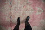 Decorative distressed pink and ivory Sparta rug with wear to foundation.