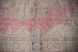 Distressed Turkish Sparta carpet close-up, showing foundation wear, faded pink, ivory, blue.