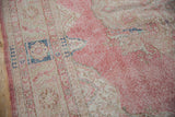 Distressed pink and ivory vintage Sparta rug with evident wear to foundation.