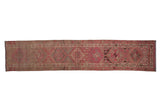Distressed Kurd runner featuring faded pink, blush, and ivory geometric medallion patterns.
