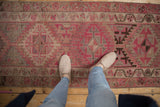 Hand knotted distressed Kurd runner, showing geometric pink, ivory, and brown patterns.