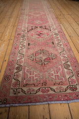 Geometric pinwheel motifs and distressed texture in pink and ivory tones.