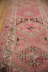 Distressed Kurd runner pile with pink, ivory, and brown softened geometric patterns.