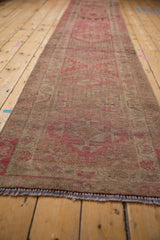 Distressed Kurd rug runner's hand-knotted pile texture with faded pink and brown geometric design.