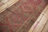 Distressed vintage Kurd runner, textural geometric patterns in muted pink, brown, and silver.