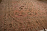 Traditional geometric guls and borders on a distressed Bokhara carpet.