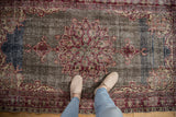 Distressed Sparta rug with deep cherry red starburst medallion on an abrashed field.