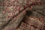 Distressed vintage Sparta rug showing folded texture, cherry red, ivory, and visible foundation.