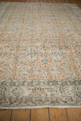 Distressed Sparta carpet border, showing muted floral motifs and worn texture.