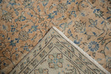 Distressed vintage Sparta carpet's folded corner reveals pile wear and woven foundation.