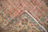 Distressed Oushak carpet showing worn red, ivory field pile and blue patterned border detail.