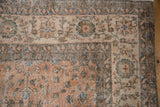Distressed Vintage Sparta rug corner with faded terracotta and ivory thousand flower motif.