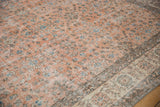 Textured pile of a Sparta carpet, showing faded terracotta and sky blue floral buds.
