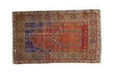 Distressed vintage Melas rug with terracotta prayer mehrab, royal blue, and faded floral designs.