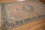 Distressed border and corner spandrel of vintage Sparta rug with navy and seafoam patterns.