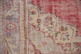 Distressed Oushak pile with worn knot heads, showing cherry red, ivory, and dusty mauve patterns.