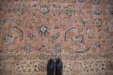 Sparta rug detail: distressed field with faded Herati motifs in pink and navy blue.