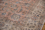 Distressed pink Sparta carpet corner, showing fine Herati floral motifs and worn pile.