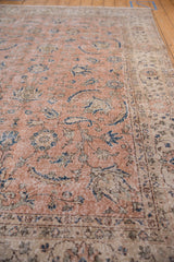 Distressed peach vintage Sparta carpet, revealing navy blue Herati leaves and floral blossoms.