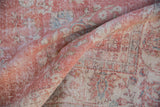 Worn texture and muted pink, ivory thousand flower design of a vintage Sparta rug.