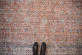 Decorative faded terracotta and blue vinery motif on a vintage Sparta rug.