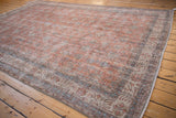 Close-up of vintage distressed Sparta carpet, faded terracotta, ivory, blue floral patterns.