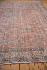 Floral vinery and dusty terracotta tones on a distressed Turkish Sparta rug border.