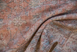Worn knot heads and distressed texture of a vintage Sparta rug in terracotta and blue.