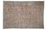 Vintage distressed Turkish Sparta carpet, faded apricot field with sprawling floral vines and ivory borders.