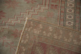 Hand-knotted Oushak rug reverse and fringe, with pale raspberry and silver tones.