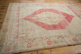 Distressed Oushak rug border, hook and latch blossoms, stepped field, faded raspberry and aqua.