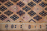 Detail of distressed Kurd runner: dark navy geometric patterns and decorative base band.