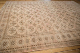 Distressed vintage Turkmen carpet showing geometric elephant footprint gul and checkered motifs.