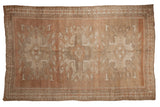 Distressed vintage Oushak carpet with an abrashed field in muted copper and beige tones.