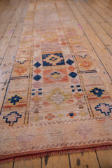 Distressed vintage Kurd runner with geometric motifs, visible foundation, and short fringe.