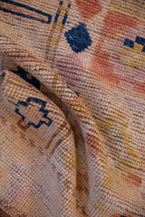 Textured distressed vintage Kurd runner pile showing worn knot heads, peach and navy geometric patterns.