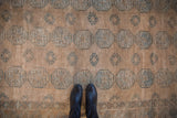 Distressed Ersari rug with pale coffee, dusty teal elephant's footprint gul motifs.