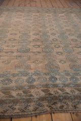 Distressed Ersari carpet, geometric elephant's footprint gul patterns in dusty teal and coffee brown.