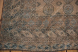 Distressed Ersari rug corner, with abrashed geometric border motifs and short fringe.