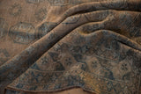 Distressed Ersari rug texture, with geometric gul motifs in dusty teal and muted brown tones.