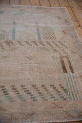 Distressed Sparta rug pile, mostly even wear showing foundation, faded brown and teal pictorials.