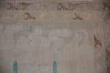 Distressed vintage Sparta rug pile with visible foundation, antique ivory, coffee brown, and dusty teal.